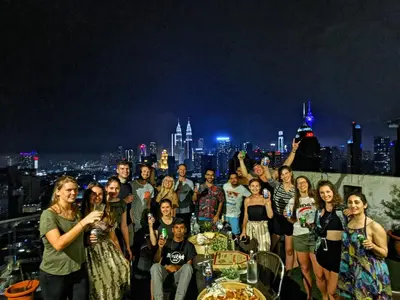 a group of people posing for a picture on a rooftop at Penthouse on 34 - The Highest Unit and Best Views in Regalia & Private Rooftop Terrace in Kuala Lumpur