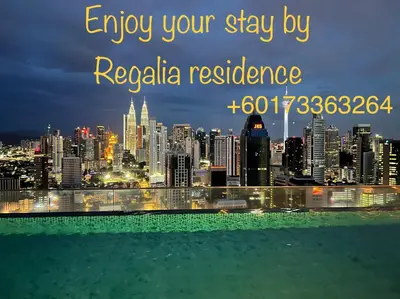 a city skyline at night with the words enjoy your stay by regalia residence at Regalia Suites & Residence by Enjoy your stay in Kuala Lumpur