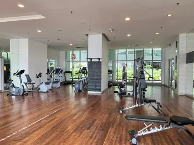 a gym with treadmills and exercise equipment in a building at Regalia Suites & Residence by Enjoy your stay in Kuala Lumpur