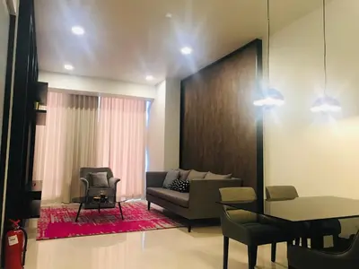 a living room with a couch and a table at Tropicana The Residence, KLCC in Kuala Lumpur