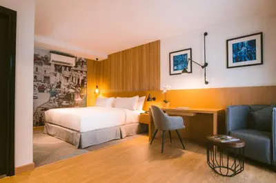 a hotel room with a bed and a desk and a couch at Indie Hotel Kuala Lumpur in Kuala Lumpur