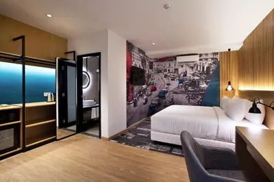 a hotel room with a bed and a desk at Indie Hotel Kuala Lumpur in Kuala Lumpur