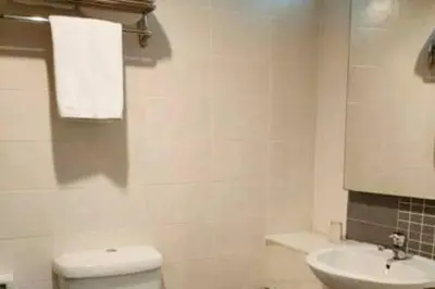 a white bathroom with a toilet and a sink at Pavilion Fahrenheit 88 Bukit Bintang 3 bedrooms in Kuala Lumpur