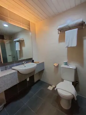 a bathroom with a toilet and a sink and a mirror at Pavilion Fahrenheit 88 Bukit Bintang 3 bedrooms in Kuala Lumpur