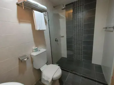 a bathroom with a toilet and a glass shower at Pavilion Fahrenheit 88 Bukit Bintang 3 bedrooms in Kuala Lumpur