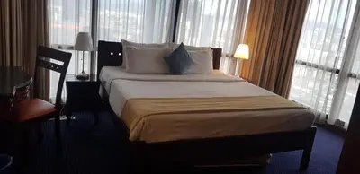 a hotel room with a large bed with white pillows at New Town Suite At Times Square in Kuala Lumpur
