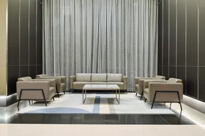 a waiting room with couches and a table at Opus Residences by Opus Hospitality in Kuala Lumpur