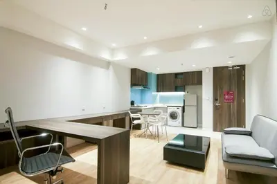 a living room and kitchen with a couch and a table at D'Majestic by Plush in Kuala Lumpur