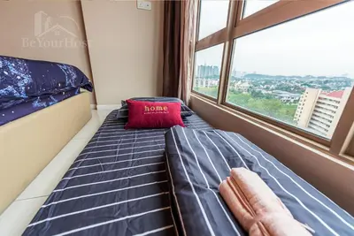 a bed in a room with a window at Dorsett Residences Sri Hartamas in Kuala Lumpur