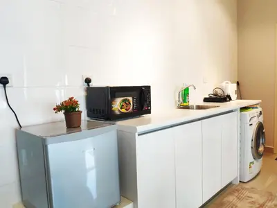 a small kitchen with a microwave on a counter at Arte Plus - Family Suite, 5 pax, Jalan Ampang in Kuala Lumpur