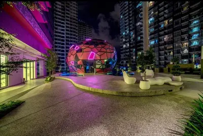 a building with a circular building with purple lights at Arte Plus - Family Suite, 5 pax, Jalan Ampang in Kuala Lumpur