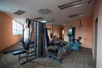 a gym with treadmills and ellipticals in a room at 231TR by Plush in Kuala Lumpur