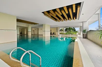 a swimming pool with blue water in a building at 231TR by Plush in Kuala Lumpur