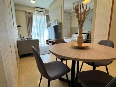 a dining table and chairs in a living room at 231TR by Plush in Kuala Lumpur