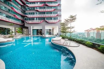 a swimming pool in front of a building at Arte Plus Kuala Lumpur in Kuala Lumpur