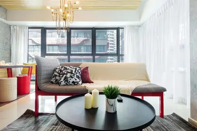 a living room with a couch and a table at Arte Plus Kuala Lumpur in Kuala Lumpur