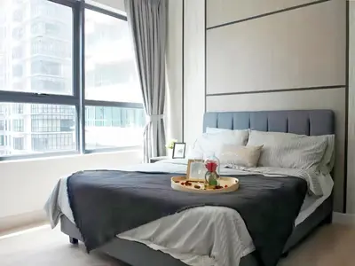a bedroom with a large bed with a tray on it at Arte Plus Kuala Lumpur in Kuala Lumpur
