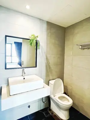 a bathroom with a white sink and a toilet at Arte Plus Kuala Lumpur in Kuala Lumpur
