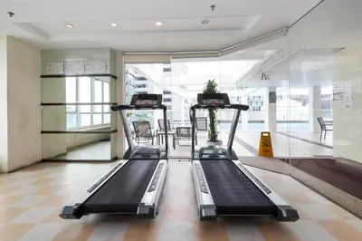 a gym with two treadmills in a building at Parkview Suites KLCC by Airhost in Kuala Lumpur