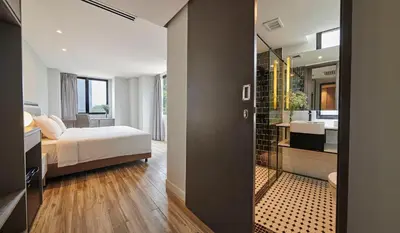 a bedroom with a bed and a bathroom at J-Hotel by Dorsett in Kuala Lumpur