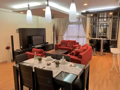 a living room with red furniture and a tv at Bukit Bintang Apartment by Sarah's Lodge @ Fahrenheit88 in Kuala Lumpur