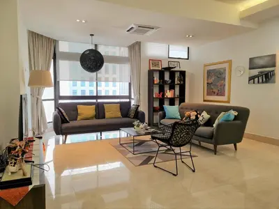 a living room with a couch and a table at Bukit Bintang Apartment by Sarah's Lodge @ Fahrenheit88 in Kuala Lumpur