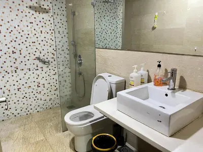a bathroom with a sink and a toilet and a shower at Regalia suites & residence 2 bedroom apartment by Enjoy your stay in Kuala Lumpur