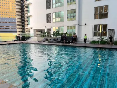 a swimming pool in the middle of a building at Regalia suites & residence 2 bedroom apartment by Enjoy your stay in Kuala Lumpur