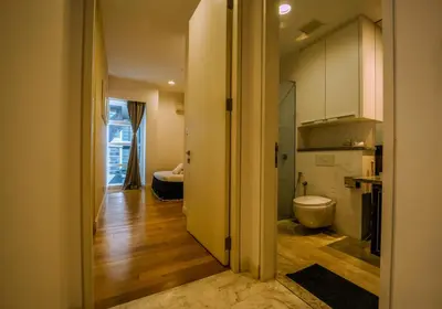a hallway leading to a bathroom with a toilet in it at La Platinum KLCC in Kuala Lumpur