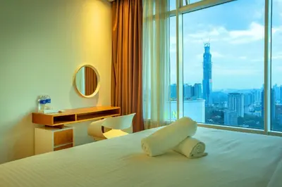 a hotel room with a bed with a large window at Yemala Suites at Vortex KLCC in Kuala Lumpur