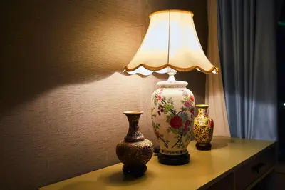 two vases sitting on a table with a lamp at Yemala Suites at Vortex KLCC in Kuala Lumpur