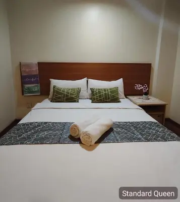 a bedroom with a large bed with towels on it at SCC Hotel City Centre in Kuala Lumpur