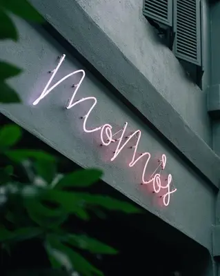 a neon sign that says rave on the side of a building at MoMo's Kuala Lumpur in Kuala Lumpur