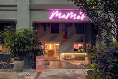 a store front with a neon sign on it at MoMo's Kuala Lumpur in Kuala Lumpur