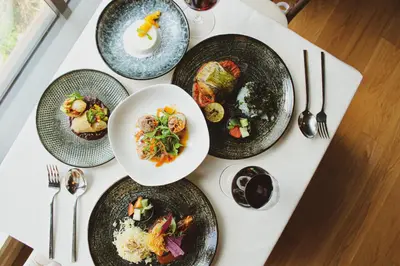 a white table with plates of food on it at The Chow Kit - an Ormond Hotel in Kuala Lumpur