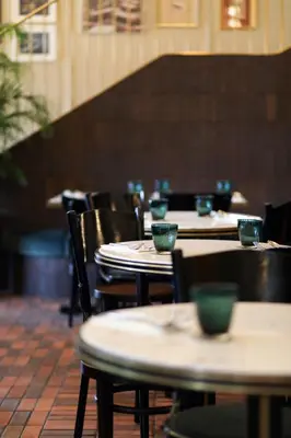 a row of tables and chairs in a restaurant at The Chow Kit - an Ormond Hotel in Kuala Lumpur