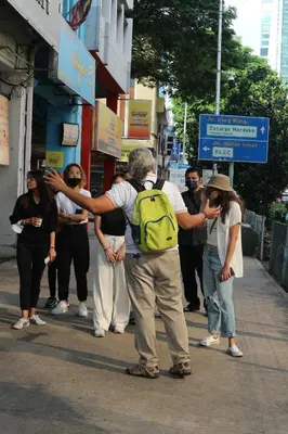 a group of people standing on a city street at The Chow Kit - an Ormond Hotel in Kuala Lumpur
