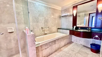 a bathroom with a bath tub and a sink at RJ Service Suite at Times Square in Kuala Lumpur