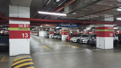 a parking garage with many cars parked in it at RJ Service Suite at Times Square in Kuala Lumpur