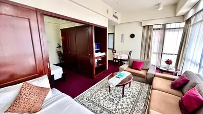 a hotel room with a bed and a living room at Rihanna service suite at times square in Kuala Lumpur