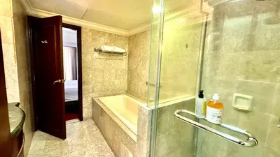 a bathroom with a shower and a tub and a sink at Rihanna service suite at times square in Kuala Lumpur