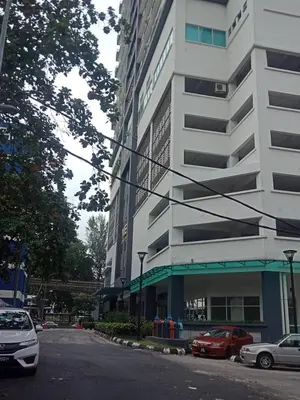 a street with cars parked in front of a building at VUE RESIDENCE SERVICE SUITE- 2 ROOMS SIZE 500SFT 4 pax in Kuala Lumpur