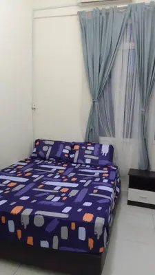 a bedroom with a bed with a blue and orange comforter at VUE RESIDENCES Jln Pahang, KL city - 2 ROOM - 4 pax in Kuala Lumpur