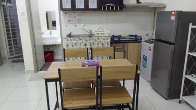 a kitchen with a table and chairs and a refrigerator at VUE RESIDENCES Jln Pahang, KL city - 2 ROOM - 4 pax in Kuala Lumpur