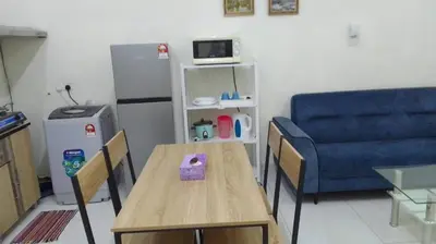 a living room with a table and a blue couch at VUE RESIDENCES Jln Pahang, KL city - 2 ROOM - 4 pax in Kuala Lumpur
