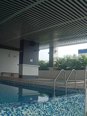 a swimming pool in a building next to a building at VUE RESIDENCES SERVICE SUITE 2 ROOMS DELUXE 6 Pax in Kuala Lumpur