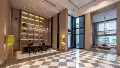 a lobby of a hotel with a table and chairs at Lanson Place Bukit Ceylon in Kuala Lumpur