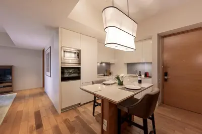 a kitchen with a table with chairs and a dining room at Lanson Place Bukit Ceylon in Kuala Lumpur