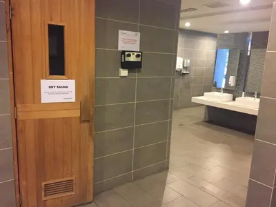 a bathroom with two sinks and a dispenser on the wall at Deluxe Swiss Garden Residences Bukit Bintang City Center in Kuala Lumpur