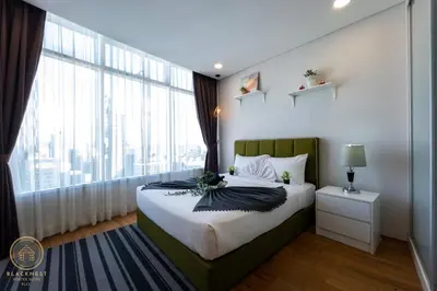 a bedroom with a bed and a large window at Vortex Suites KLCC by BlackNest in Kuala Lumpur